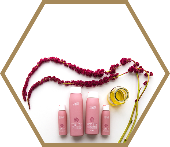 A group of pink bottles and some red beads